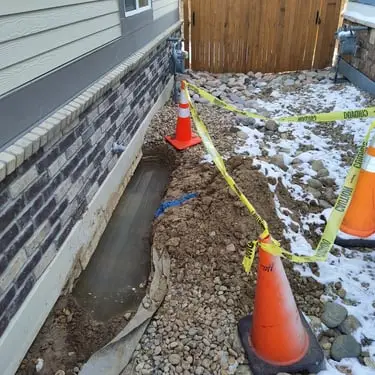 Leak Detection being performed on the side of a house with water visible