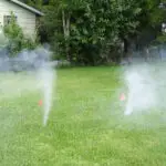 sewer leaking smoke in a yard during a sewer smoke test